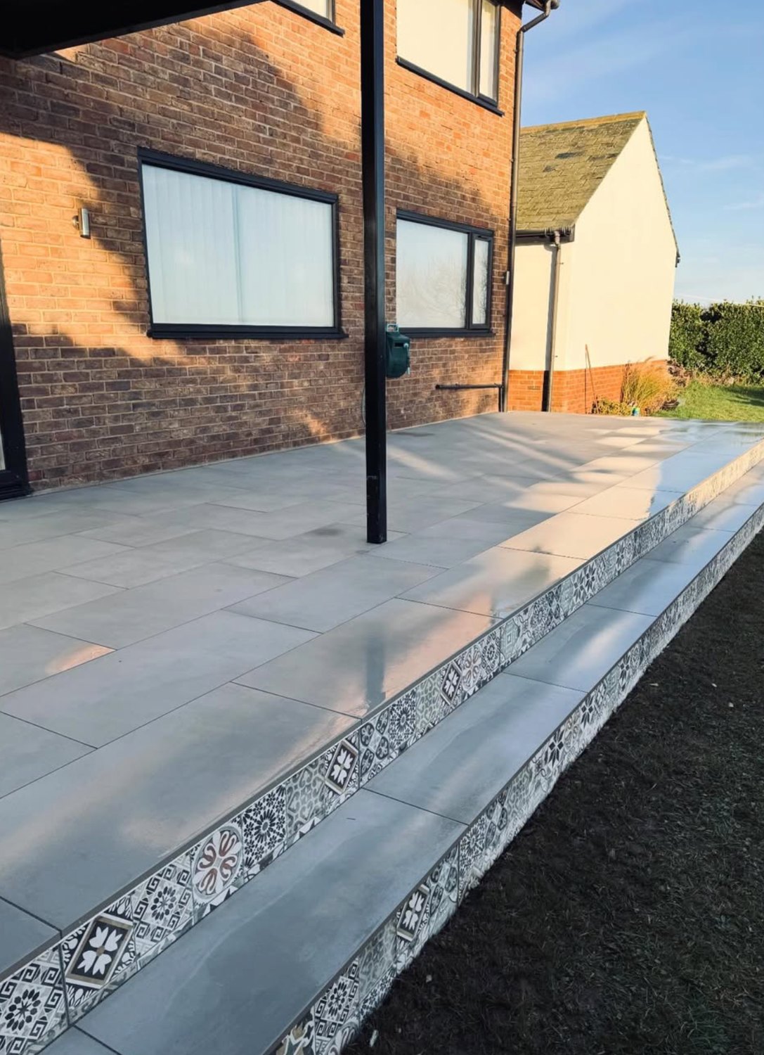 Raised porcelain terrace with decorative tiled steps